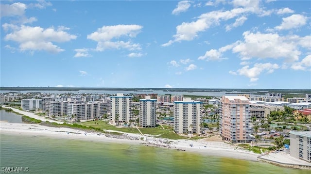 aerial view featuring a view of city, a water view, and a beach view