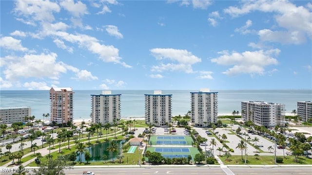 birds eye view of property with a water view and a city view