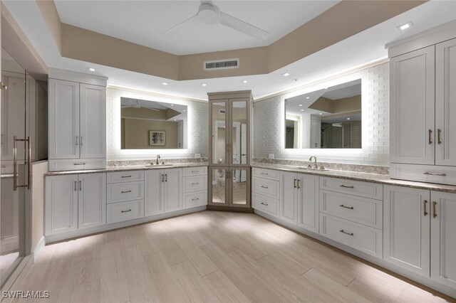 bathroom with vanity, hardwood / wood-style floors, and ceiling fan