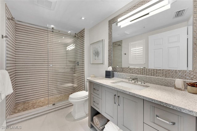 bathroom with walk in shower, vanity, toilet, and tile patterned flooring