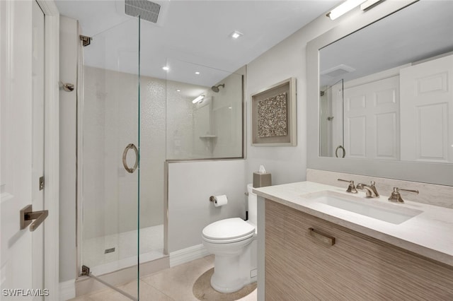 bathroom with vanity, toilet, a shower with shower door, and tile patterned flooring