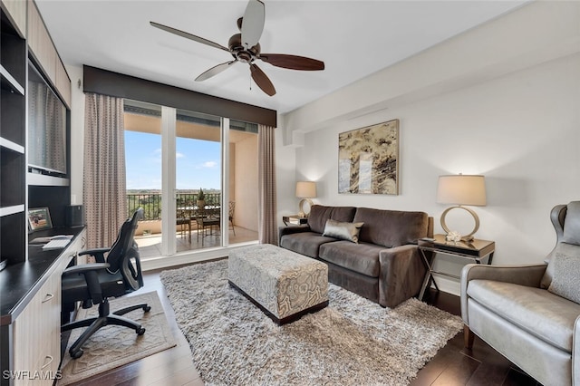 office area with built in desk, dark hardwood / wood-style floors, and ceiling fan