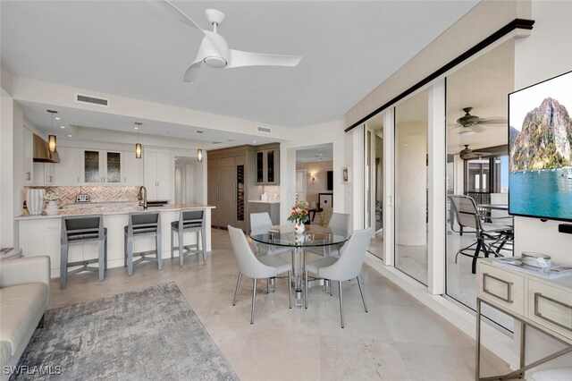 dining room with sink and ceiling fan