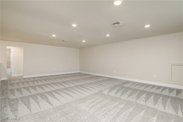 unfurnished room featuring light carpet