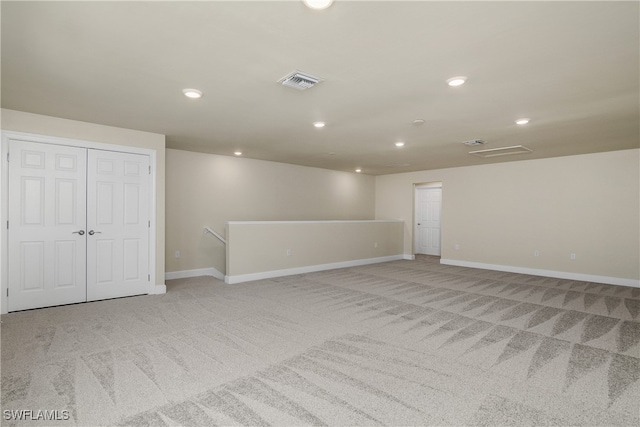 empty room featuring light carpet