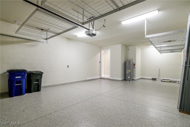 garage with a garage door opener and electric water heater