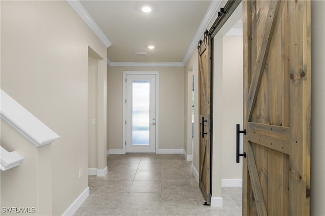 interior space featuring light tile patterned floors, ornamental molding, and a barn door