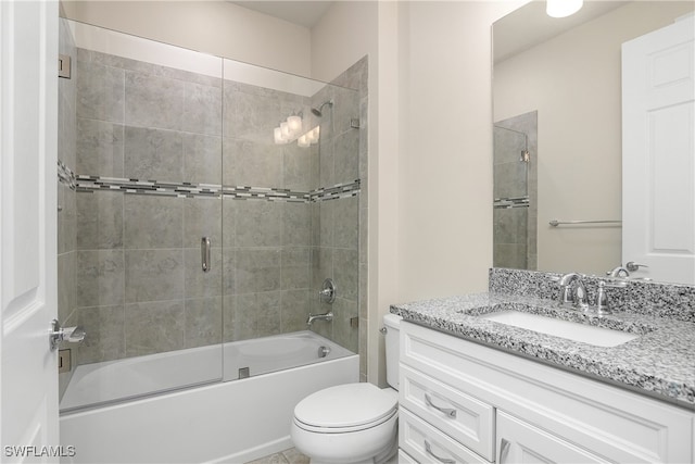 full bathroom featuring enclosed tub / shower combo, vanity, and toilet