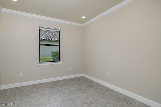 empty room featuring crown molding