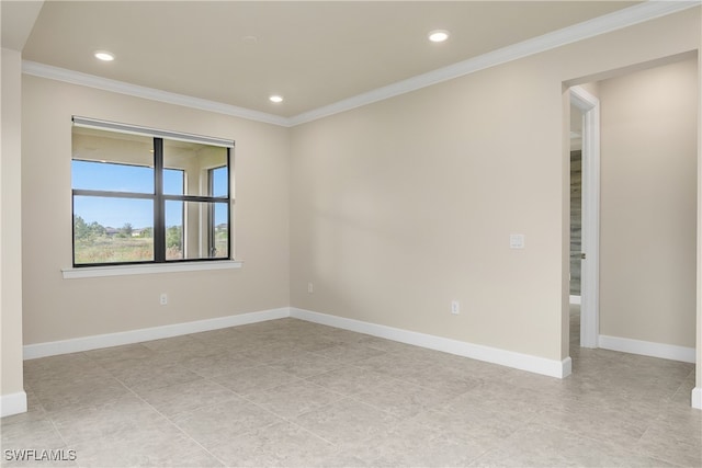 empty room featuring crown molding