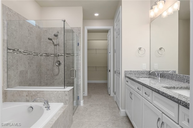 bathroom featuring vanity, tile patterned floors, and separate shower and tub