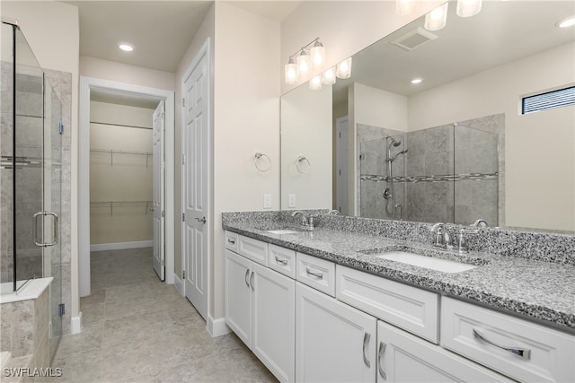 bathroom featuring vanity and an enclosed shower