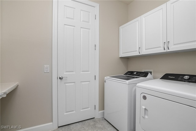 laundry room featuring cabinets and independent washer and dryer