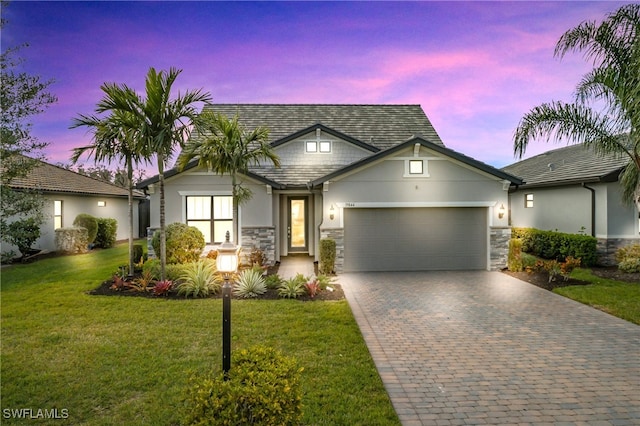 view of front of house featuring a lawn and a garage