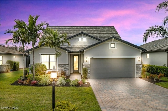 view of front facade with a garage and a lawn