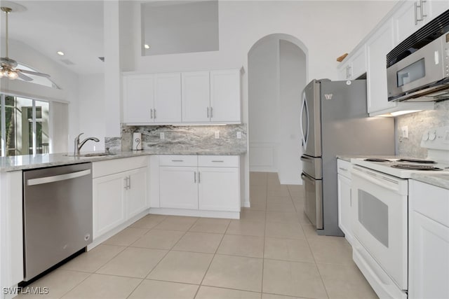 9234 Springview Loop, Estero, FL 33928 - kitchen featuring stainless steel appliances, tasteful backsplash, a ceiling fan, a sink, and white cabinets