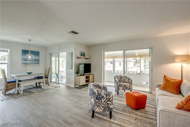 living room with plenty of natural light and light wood-type flooring