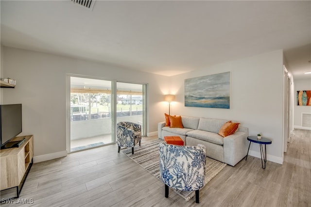 living room with light hardwood / wood-style flooring