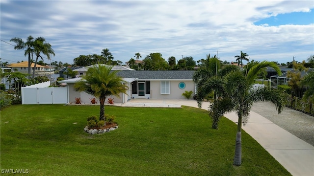 single story home featuring a front lawn