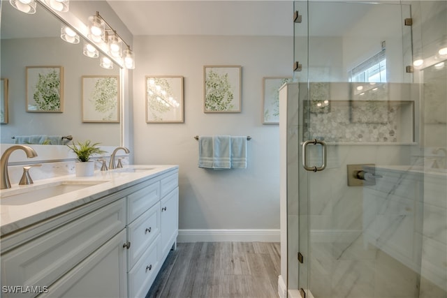 bathroom with an enclosed shower, vanity, and hardwood / wood-style floors