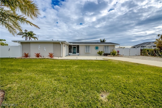 view of front of house featuring a garage and a front lawn