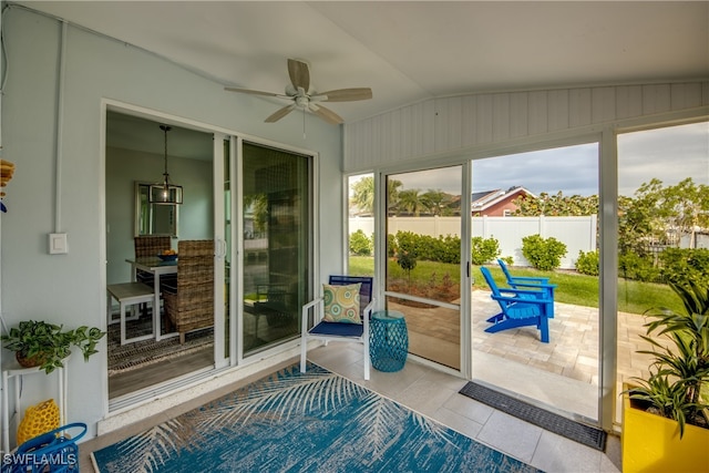 sunroom featuring lofted ceiling and ceiling fan