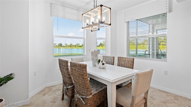 dining room with ornamental molding and an inviting chandelier