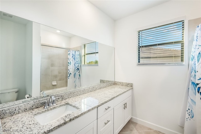 bathroom with vanity, tile patterned floors, and toilet