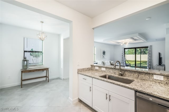 kitchen with sink, white cabinetry, an inviting chandelier, dishwasher, and light stone countertops