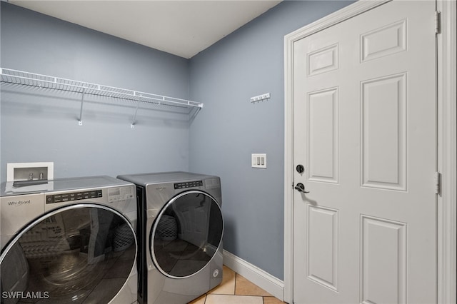 laundry room with light tile patterned flooring and separate washer and dryer