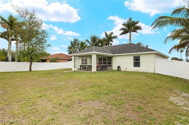 back of house featuring a patio and a lawn