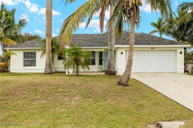 ranch-style house featuring a front yard and a garage