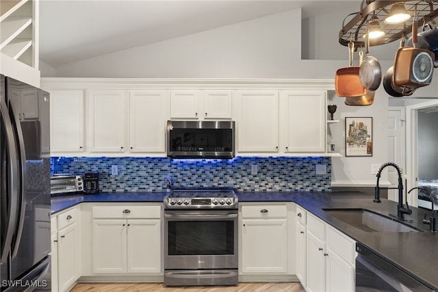 kitchen with sink, backsplash, white cabinets, and black appliances