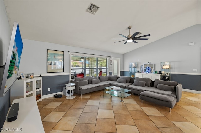 living room featuring light tile patterned flooring, ceiling fan, and vaulted ceiling