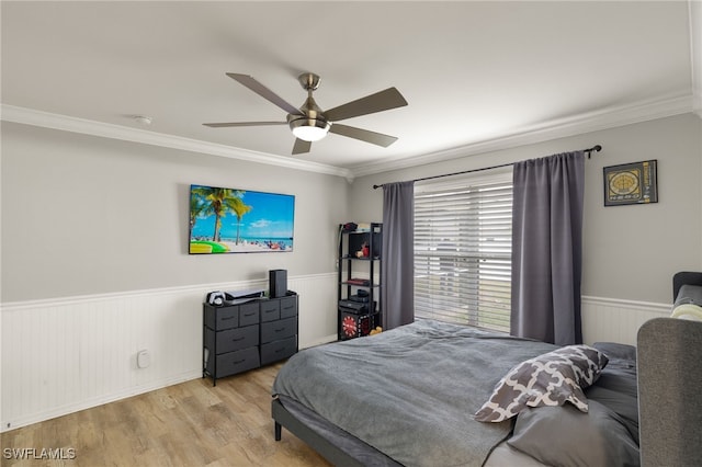 bedroom with ceiling fan, crown molding, and light hardwood / wood-style flooring