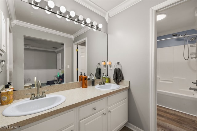 bathroom featuring hardwood / wood-style floors,  shower combination, crown molding, and vanity