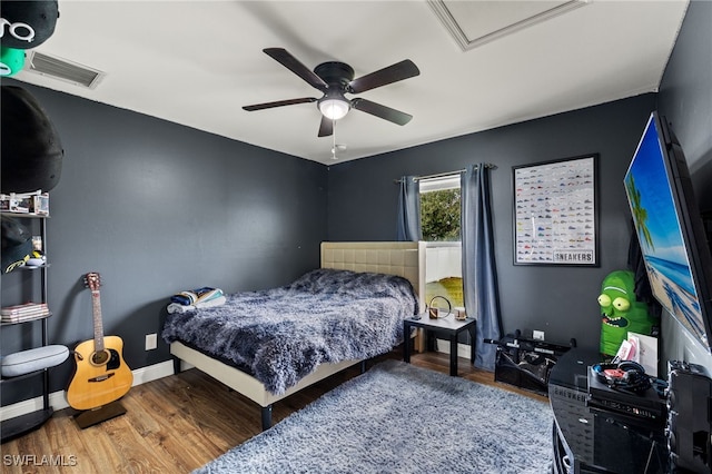 bedroom with ceiling fan and hardwood / wood-style flooring