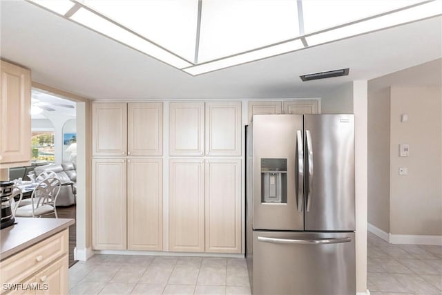 kitchen featuring stainless steel fridge with ice dispenser and light tile patterned floors