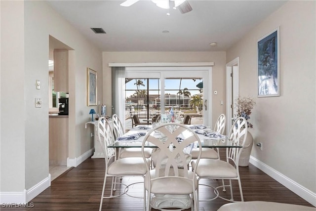 dining area with dark hardwood / wood-style floors and ceiling fan