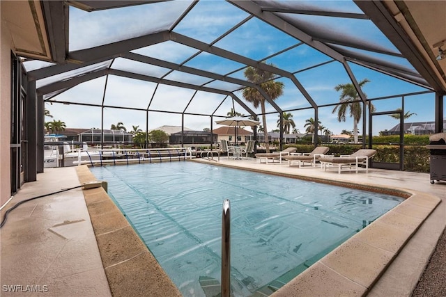 view of swimming pool with a patio and glass enclosure