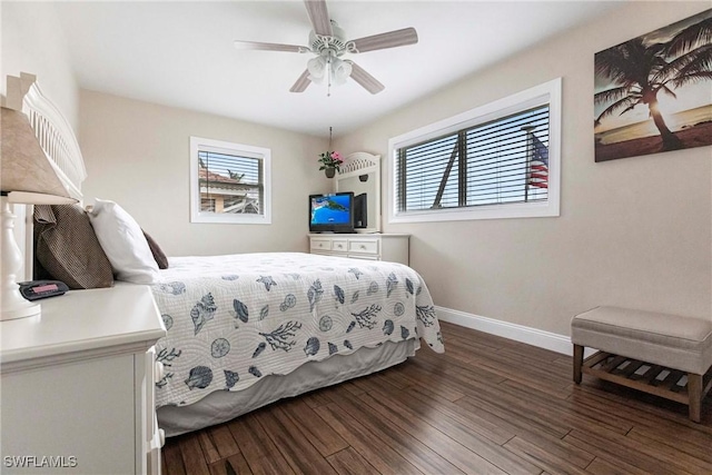 bedroom with ceiling fan, dark hardwood / wood-style floors, and multiple windows