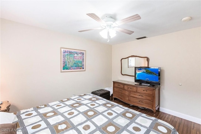 bedroom with ceiling fan and dark hardwood / wood-style floors