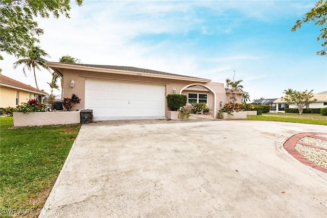 ranch-style home featuring a garage and a front lawn