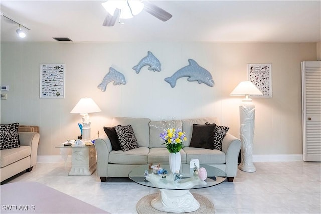 tiled living room with ceiling fan