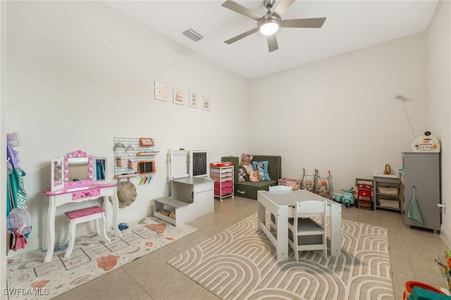 game room with ceiling fan and light tile patterned floors