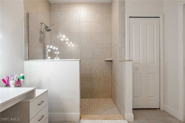 bathroom featuring vanity, tile patterned floors, and tiled shower