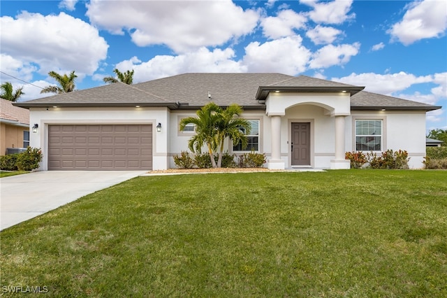 view of front of house featuring a front lawn and a garage