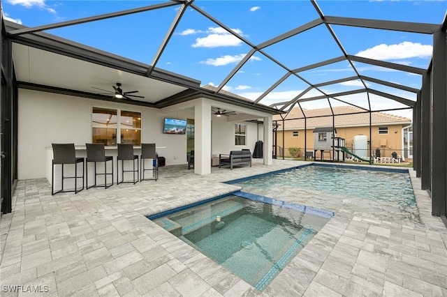 view of swimming pool featuring a lanai, outdoor lounge area, exterior bar, an in ground hot tub, and a patio