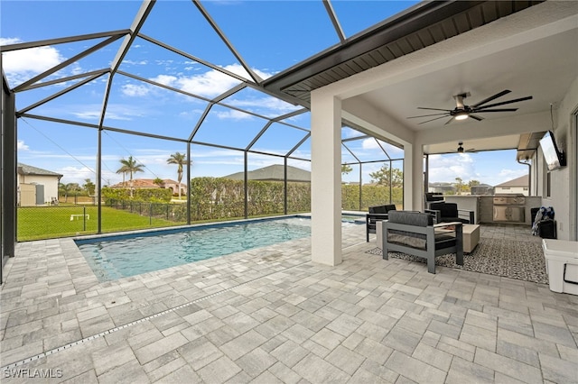 view of pool featuring a lanai, a patio area, an outdoor kitchen, and a yard