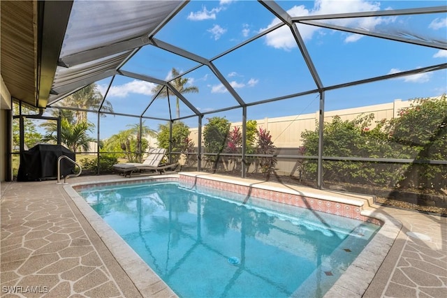 view of pool with a patio area, a lanai, and grilling area